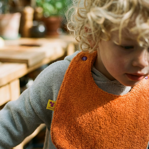 Reversible Bib terry orange/muslin mauve