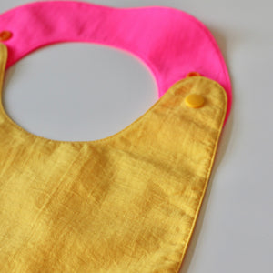 Reversible Bib yellow/fuchsia
