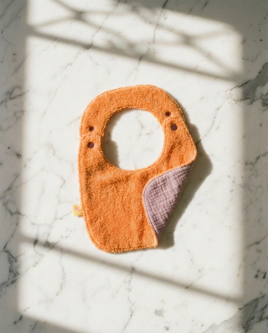 Reversible Bib terry orange/muslin mauve